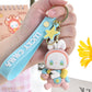 Lucky Emma Baby Keychain, this is one of the many options you can get, displayed by a person holding the keychain