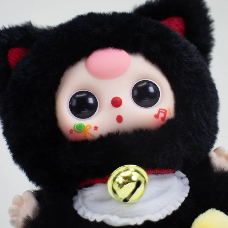 Black cat plush kawaii blind box toy with colorful face and bell on a white background