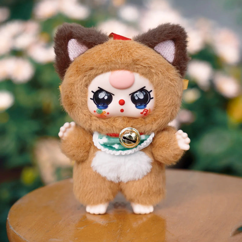 Plush toy with cat-like design on a wooden surface with a blurred floral background