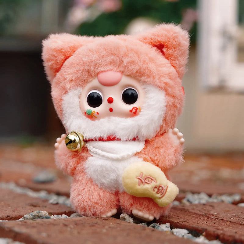 Plush kawaii blind box toy with a pink hood and white face on a blurred background