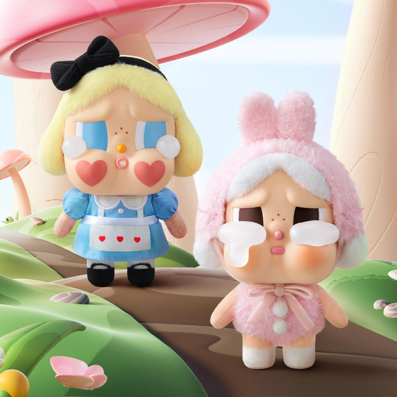 Crybaby blind box figures, one with blonde hair and the other with rabbit ears, standing on a colorful landscape.
