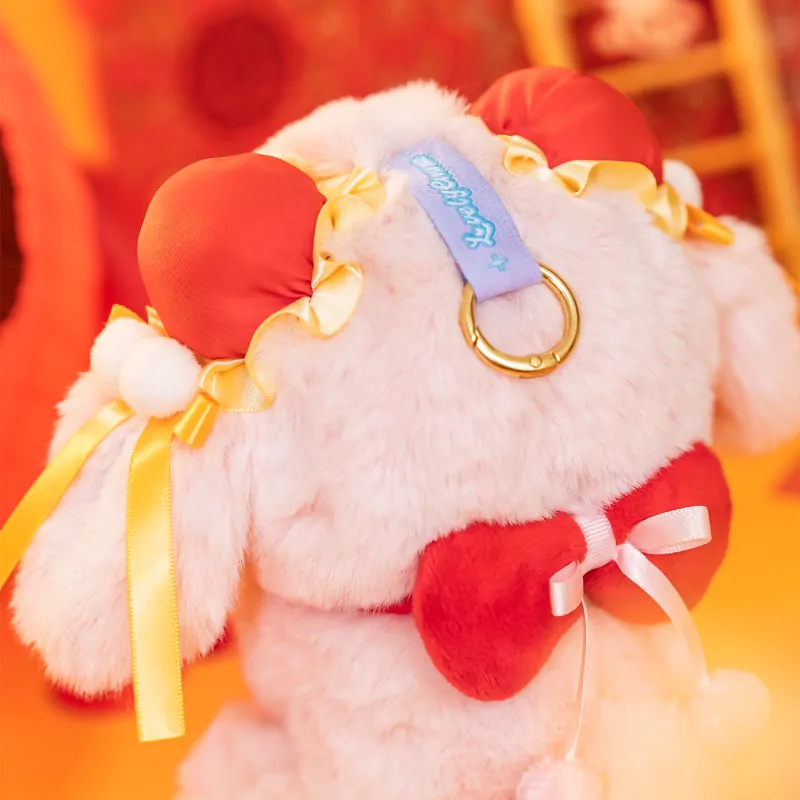 Plush toy with red heart and yellow ribbons on a blurred background