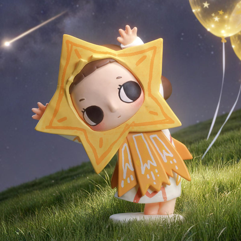 Toy figure of a child in a star-shaped raincoat standing on grass with a night sky and balloons in the background.