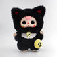 Plush toy with black cat ears and face, wearing a black outfit with yellow accents on a white background