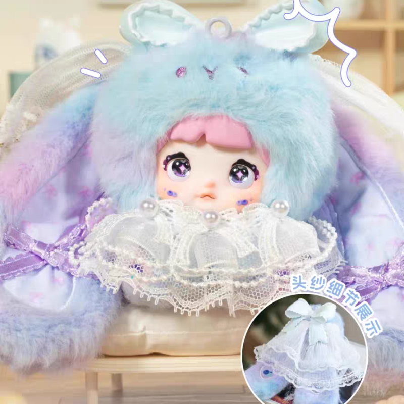 Toy figure with blue hair and pink face, wearing a decorative headpiece, on a blurred background.