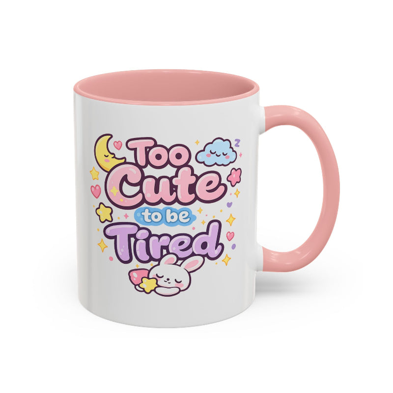 White mug with pink interior and handle, featuring 'Too Cute to be Tired' text and a kawaii bunny on a white background.