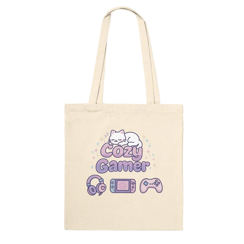 Beige tote bag with 'Cozy Gamer' design featuring a cat, gaming console, and controller on a white background.