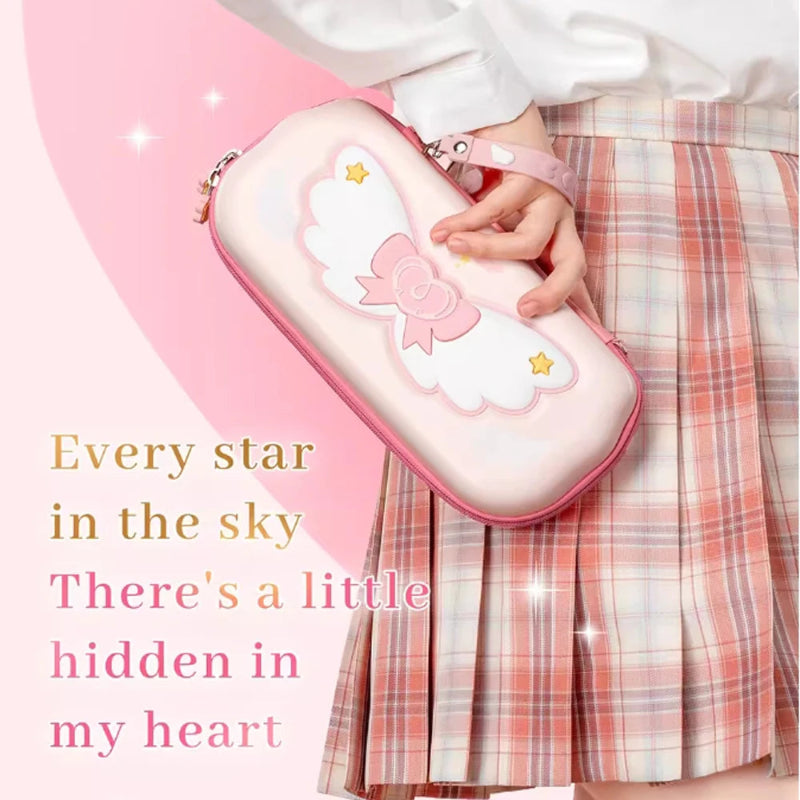 Person holding a pink Nintendo Switch case with a wings and star design, wearing a plaid skirt.