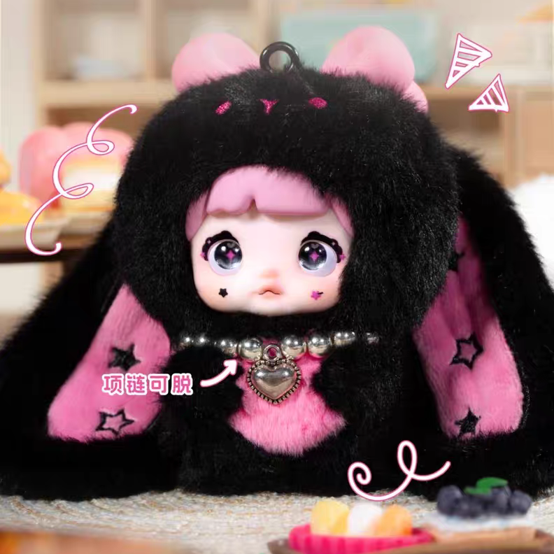 Toy figure with black fur and pink accents on a table with snacks