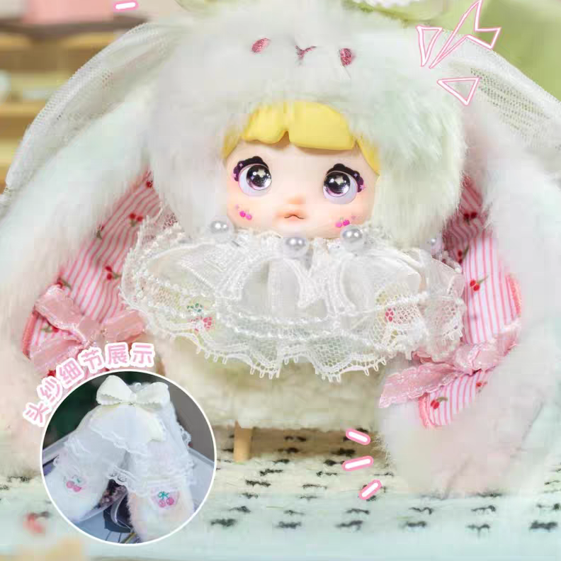 Toy figure in a decorative white outfit with pink accents on a patterned surface.