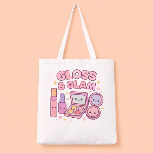 Kawaii Tote Bag with "Gloss and Glam" text featuring a kawaii design of lip gloss, nail polish, an eyeshadow pallette and a powder compact with a mirror.