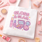 Kawaii Gloss & Glam Tote Bag on a pink surface surrounded by beauty products.