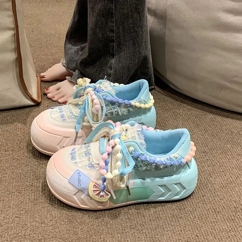 Pair of kawaii pastel sneakers against a carpet.