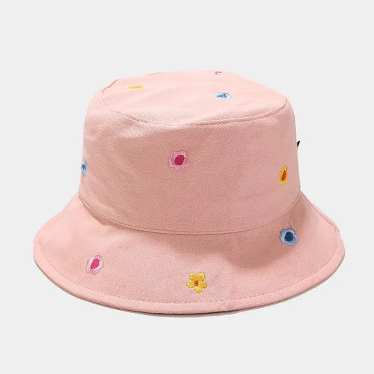 Pink bucket hat with colorful flower patterns on a light gray background