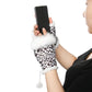 Person wearing a leopard print glove with white fur trim, holding a smartphone.