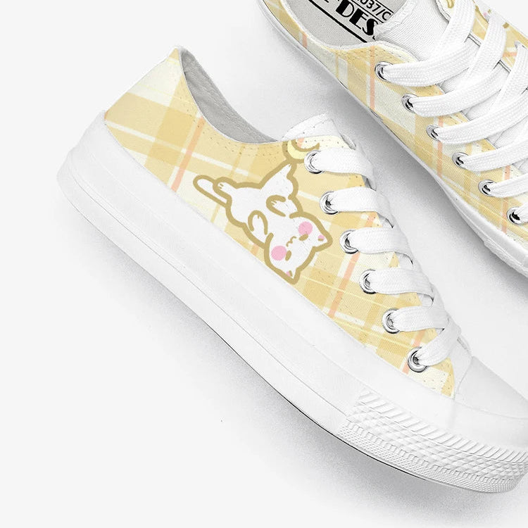White sneakers with a kawaii cat design on a white background