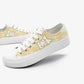 Pair of white kawaii sneakers with yellow plaid  pattern on a white background