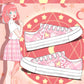 Anime character with pink hair wearing pink sneakers on a decorative background with stars and geometric shapes.