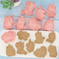 Unicorn-shaped cookie cutters and silicone molds on a blue wooden surface.
