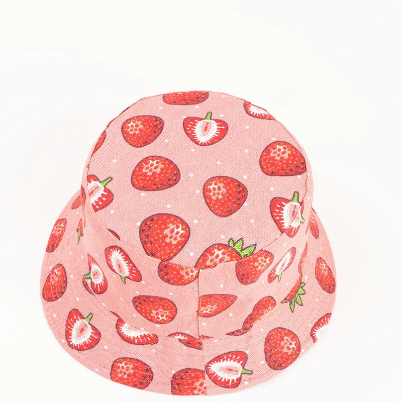 Pink hat with strawberry pattern on a white background