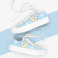 White sneakers with kawaii character design on a white and blue background