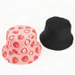 Pink bucket hat with cute strawberry pattern and black bucket hat on a white background