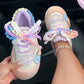 Kawaii Pastel-colored sneakers with decorative pearl 
laces held by a hand.