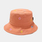 Orange bucket hat with floral patterns on a light grey background