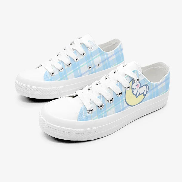 White kawaii sneakers with blue and yellow design on a white background