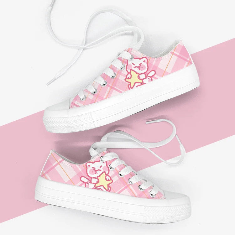 Pink kawaii sneakers with cute cat designs on a pink and white striped background