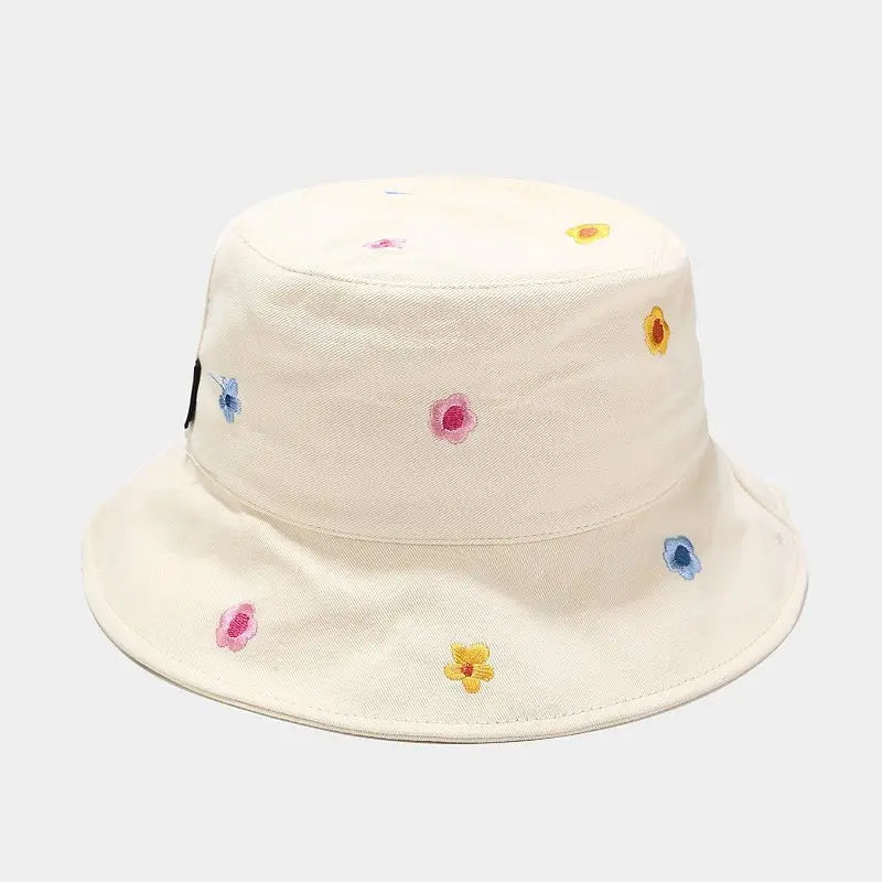 Beige bucket hat with colorful flower patterns on a white background
