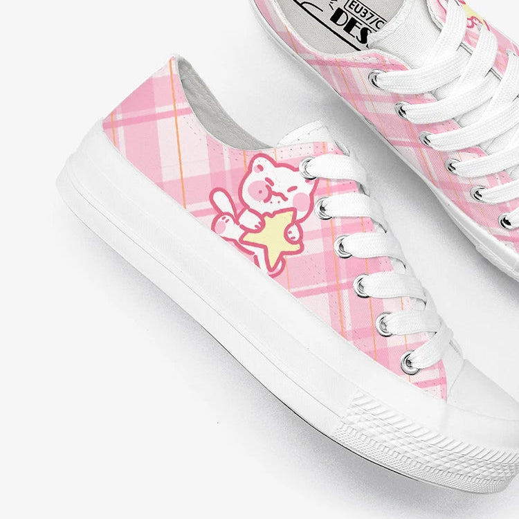 White sneakers with pink plaid pattern and kawaii cat character on a white background