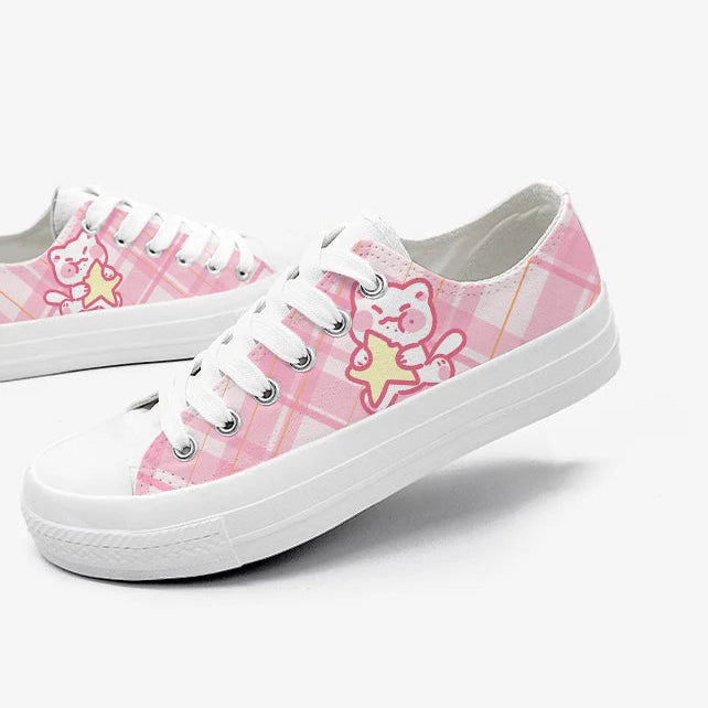 Pink sneakers with kawaii cat character design on a white background