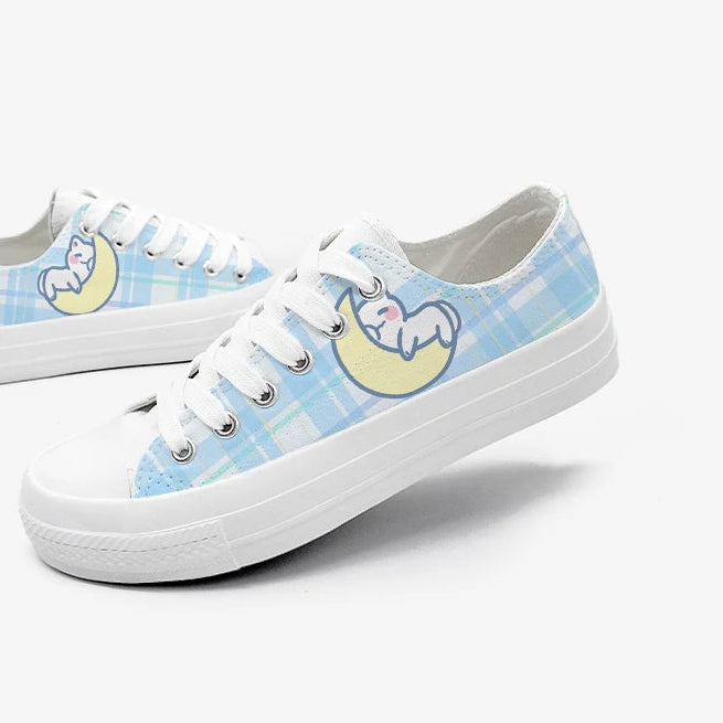 Pair of blue checkered sneakers with a kawaii design on a white background