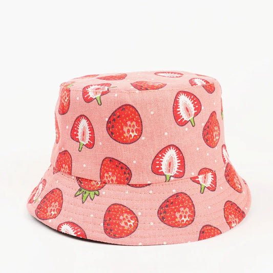 Pink bucket hat with strawberry pattern on a white background