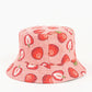 Pink bucket hat with strawberry pattern on a white background