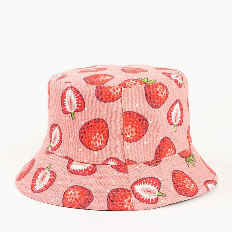 Pink bucket hat with strawberry pattern on a white background