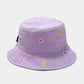 Purple bucket hat with floral embroidery on a light gray background