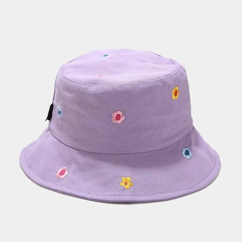 Purple bucket hat with floral embroidery on a light gray background