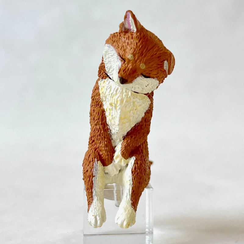 Toy fox figure on a clear stand against a white background
