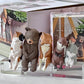 Set of animal figurines on a clear stand with books in the background