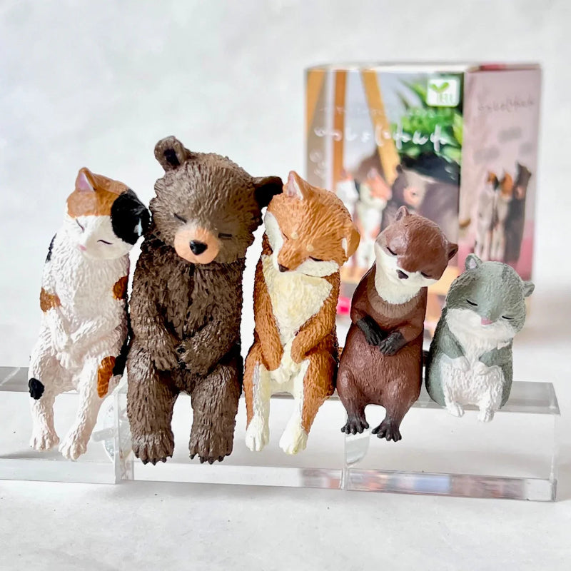 Collection of animal figurines on a clear stand with a white background