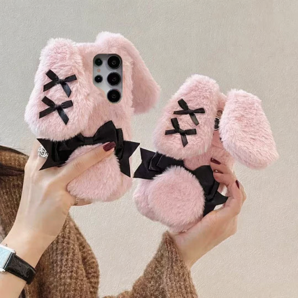 woman holding a Kawaii Plush Bunny Samsung Phone Case to display the back of the case , showing off the floppy pink bunny ears.