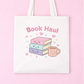 Tote bag with 'Book Haul' text and book illustrations on a pink background