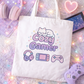 Tote bag with 'Cozy Gamer' design on a pastel background with gaming accessories.
