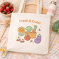 Kawaii Farmer's market tote back that says "Fresh & Cute" and has a kawaii veggie, fruit, and flower design.