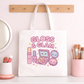 Kawaii Gloss and Glam Tote bag on a table next to a cup with makeup brushes