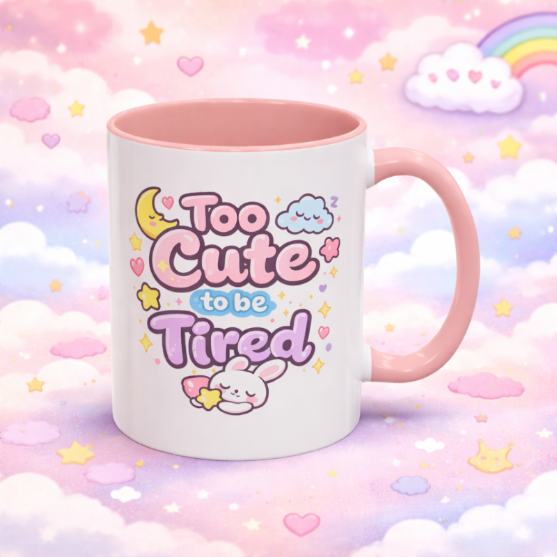 Cute mug with 'Too Cute to be Tired' text on a pastel cloud background