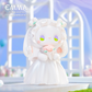 Kawaii figurine in a white dress holding a pink flower against a blurred background with 'EMMA' branding.