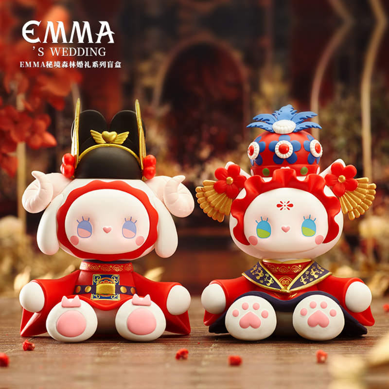 Two kawaii character figurines in traditional attire on a wooden surface with 'EMMA'S WEDDING' branding.